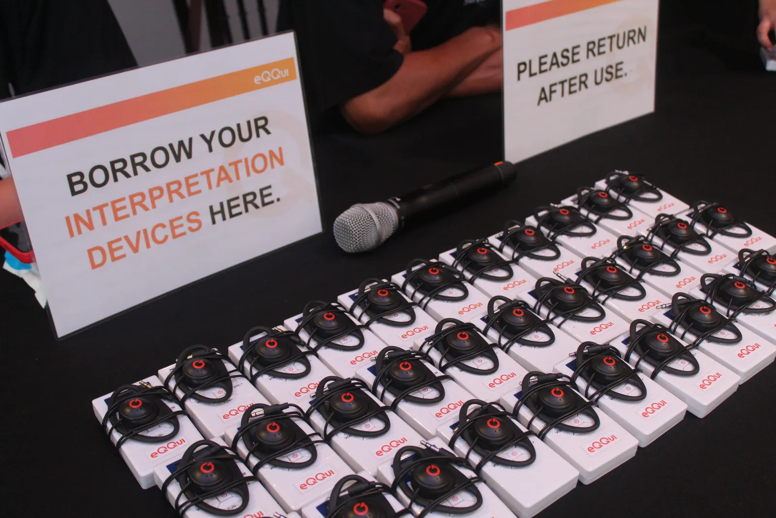 eQQui PH interpretation receiver devices laid out for conference attendees