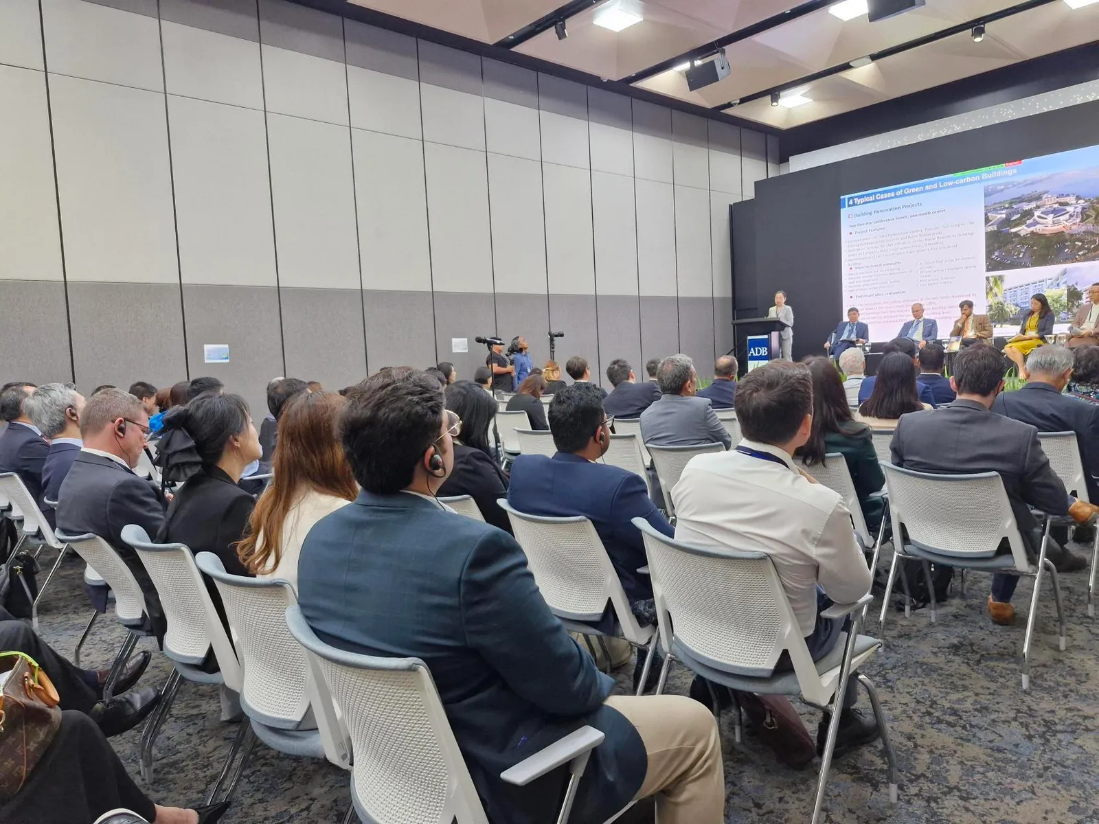 Conference audience with interpretation earpieces at an ADB event